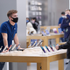 An Apple store employee wearing a mask at a store in Tampa, Florida on Black Friday on Nov. 26, 2021.